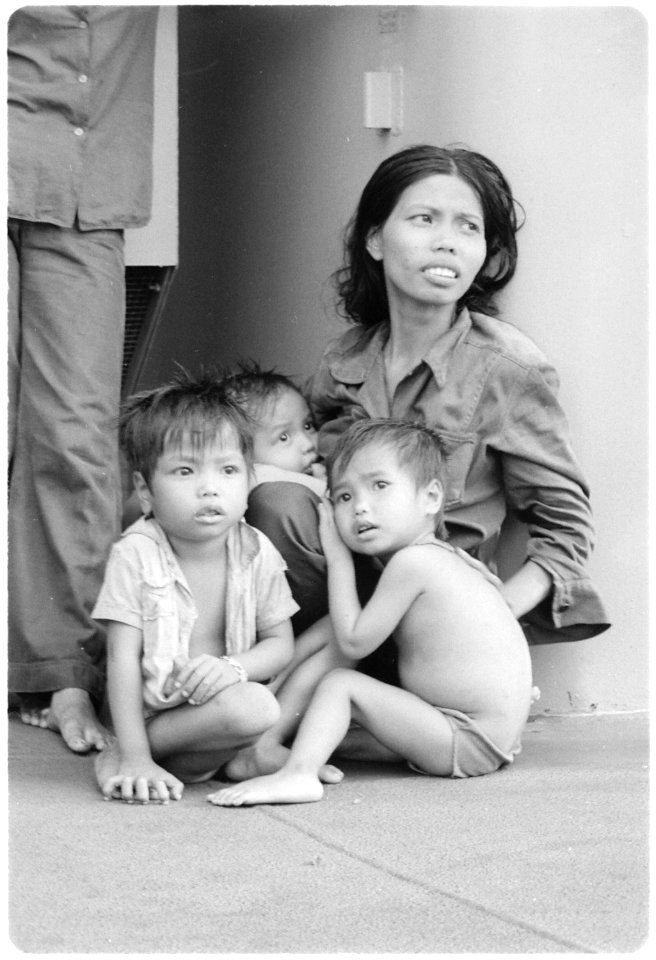 South China Sea....A refugee woman cares for three small children on the replenishment oiler USS Wabash, AOR-5.... - NARA - 558538