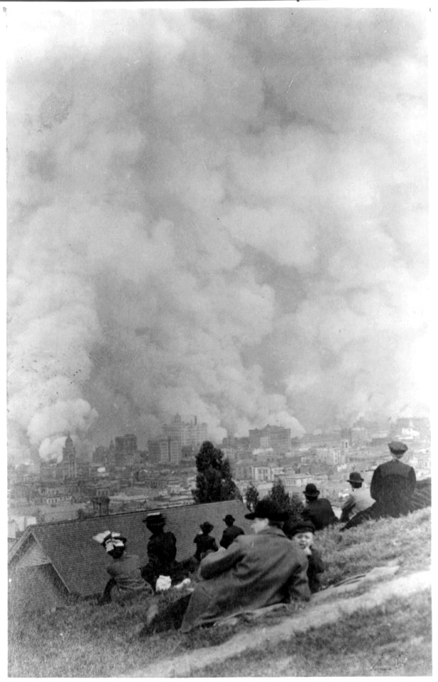 Spectators sitting on hillside watching fires consume the city after the 1906 San Francisco earthquake LCCN2007681309