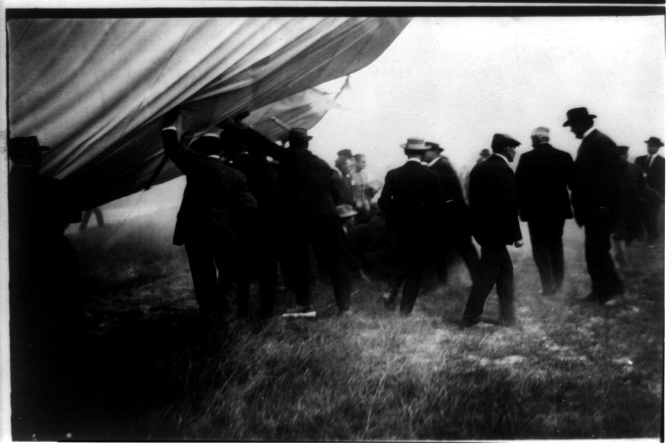 Spectators lifting the aeroplane from the bodies of the injured men LCCN2002721850