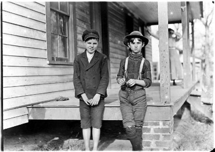 Springstein Mill. John Lewis (boy with hat), 12 years old, 1 year in mill. Weaver - 4 looms. 40 (cents) a day to... - NARA - 523117 photo
