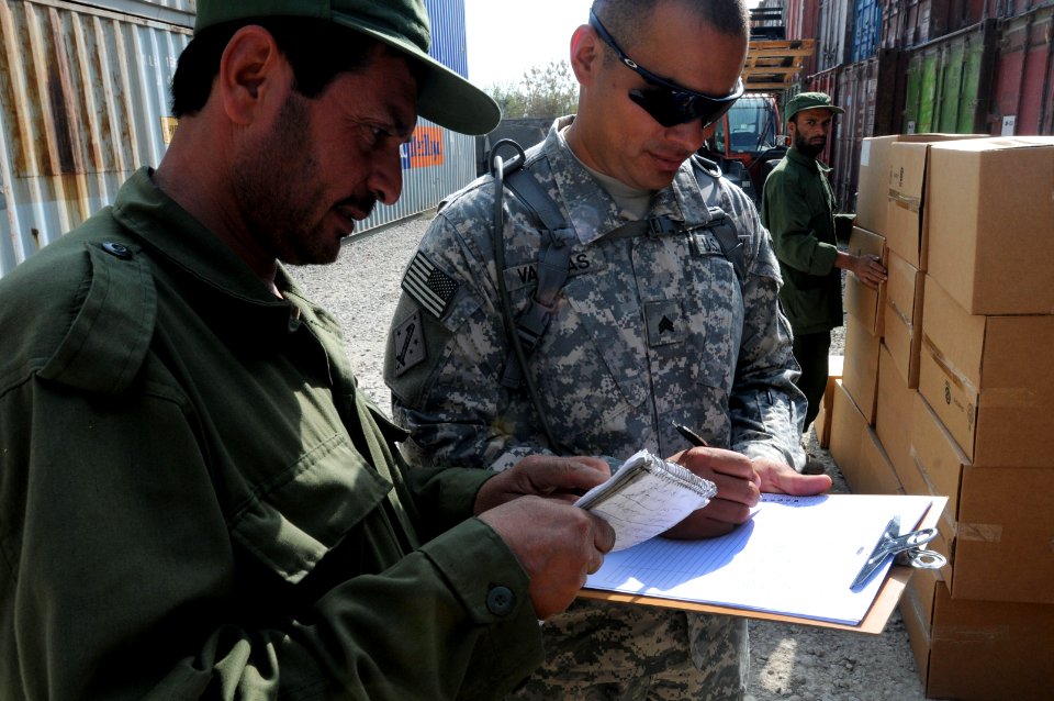 Srgt. Francisco Vargas conducts inventory alongside local Afghan contractors (5092962132)