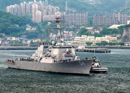 Starboard bow view of USS Curtis Wilbur (DDG-54) assisted by tug while departing Yokosuka 180517-N-GH917-0001