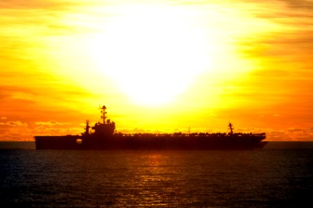 Starboard beam view of USS George Washington (CVN-73) during an underway replenishment in the South China Sea with sunrise in background 120708-N-TX154-097