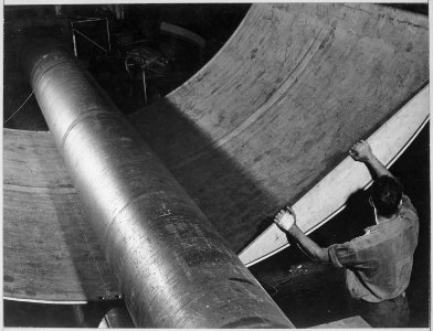 Steel under giant rolls being shaped for submarine construction at Electric Boat Company in Groton, Connecticut - NARA - 520848