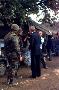 Steny Hoyer and US Army soldiers pose for local media photographs in the town of Brod