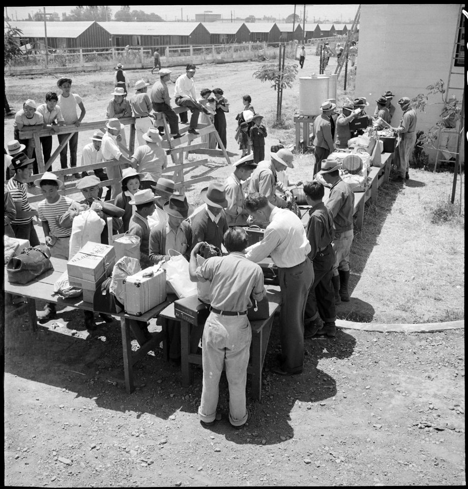 Stockton, California. Hand baggage is being inspected for contraband upon the arrival of evacuees o . . . - NARA - 537726
