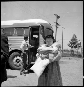 Stockton, California. Young mother of Japanese ancestry arrives at Assembly center with 21 day old baby. - NARA - 537719