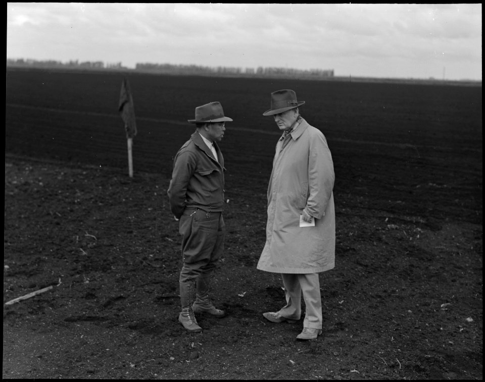 Stockton, California. Henry T. Futamachi (left), superintendant of a 1300-acre mechanized ranch, di . . . - NARA - 536030
