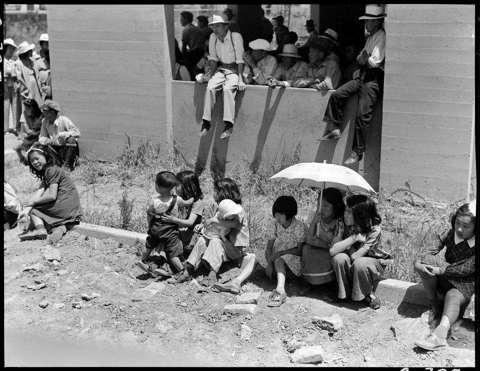 Stockton, California. These evacuees of Japanese ancestry are watching the arrival of buses bringin . . . - NARA - 537727