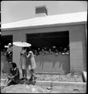 Stockton, California. These evacuees of Japanese ancestry are watching the arrival of buses bringin . . . - NARA - 537729