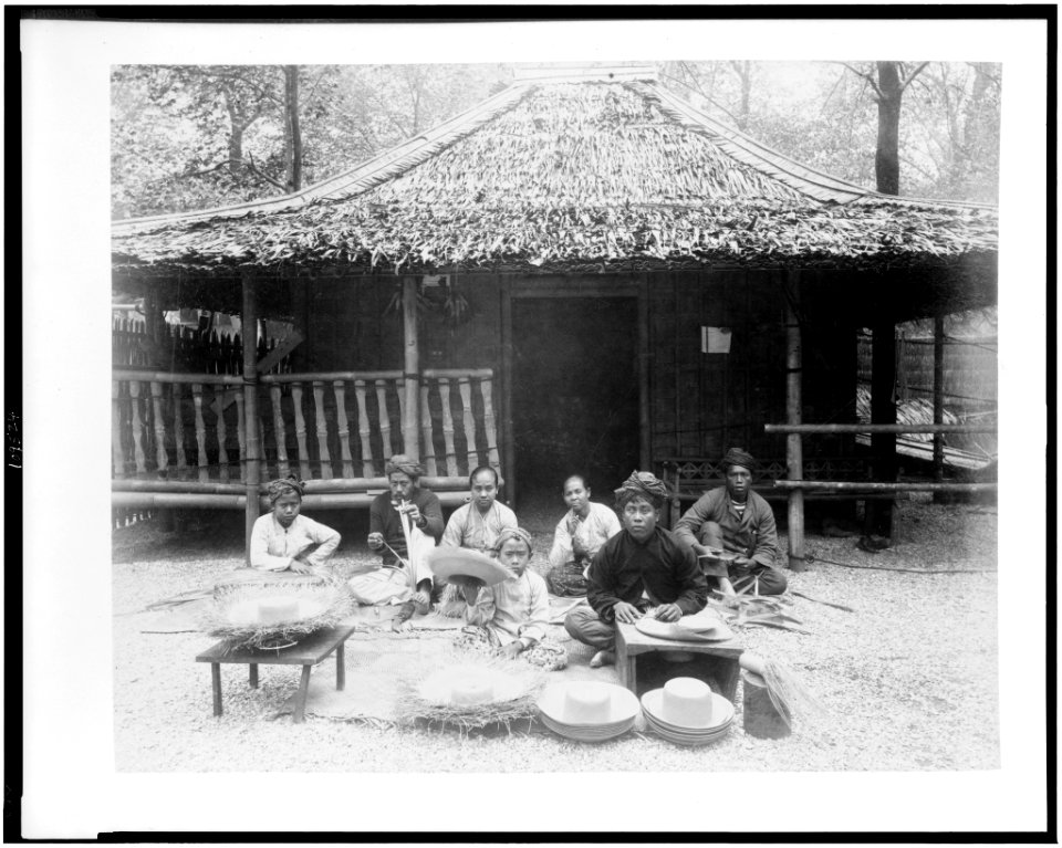 Straw hat makers in Javanese Village seated before Javanese house, Paris Exposition, 1889 LCCN94500848