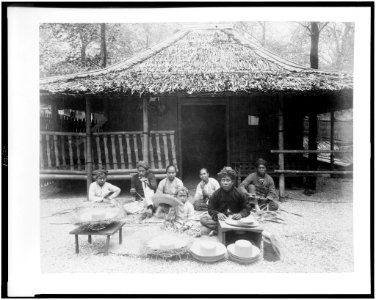 Straw hat makers in Javanese Village seated before Javanese house, Paris Exposition, 1889 LCCN94500848