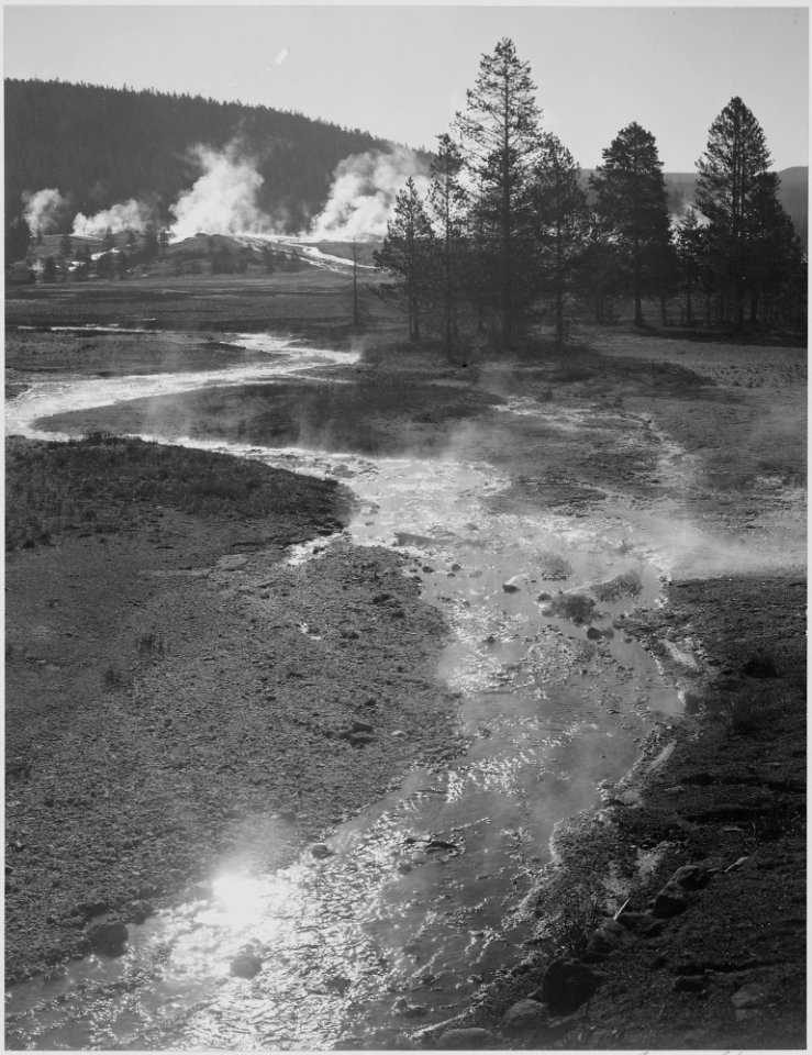 Stream winding back toward geyser, Central Geyser Basin, Yellowstone National Park, Wyoming. (Vertical orientation), 1 - NARA - 519991