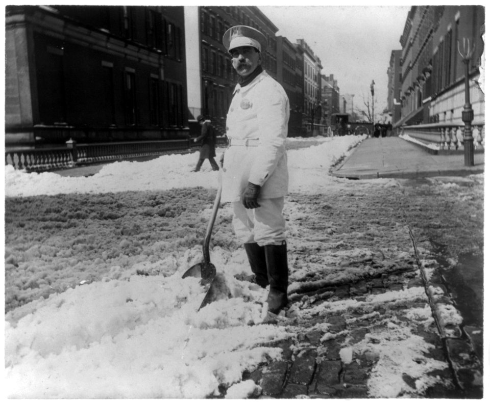 Street types of New York City- Street cleaner with rubber boots shoveling snow LCCN2002699102
