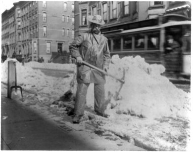 Street types of New York City- Street cleaner with pick ax standing in front of pile of snow LCCN2002699104 photo