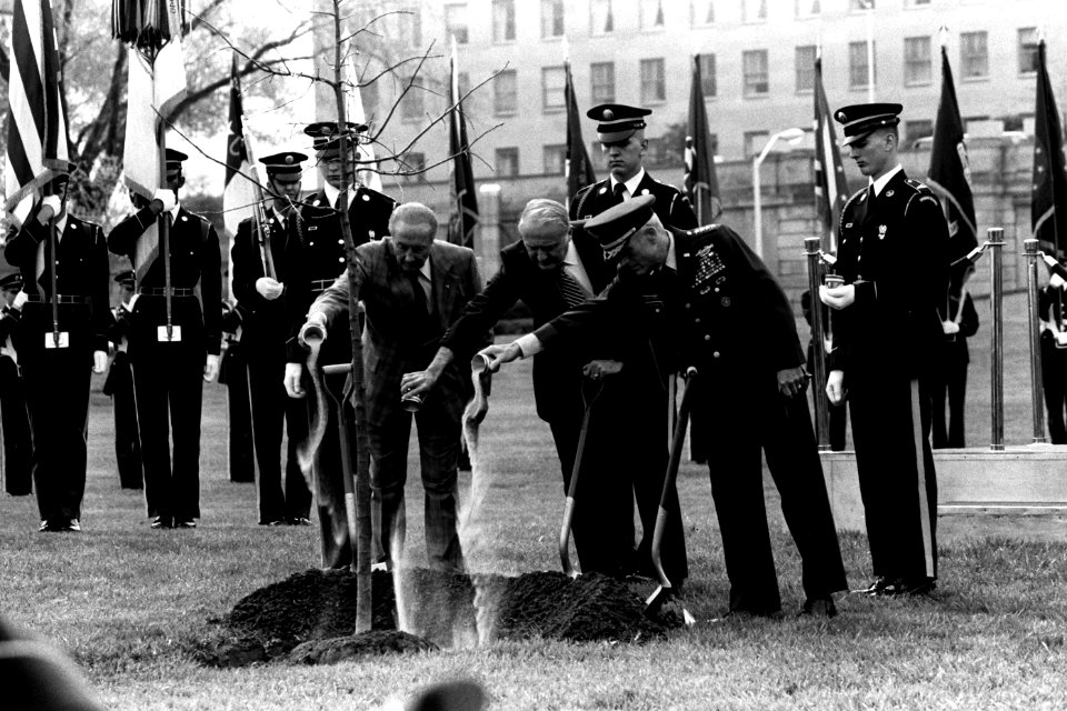 Strom Thurmond, John Marsh, and John Wickham pour sand from the beaches of Normandy, France, into a hole during an Arbor Day tree-planting ceremony outside the Pentagon