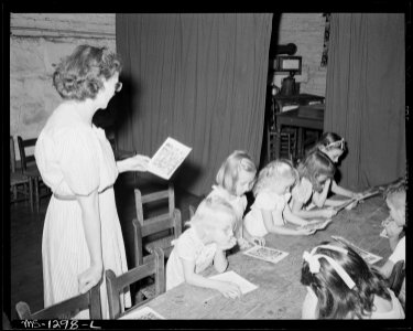 Sunday school in white church. Church services are held in community building supplied by company. Part-time preacher... - NARA - 540772