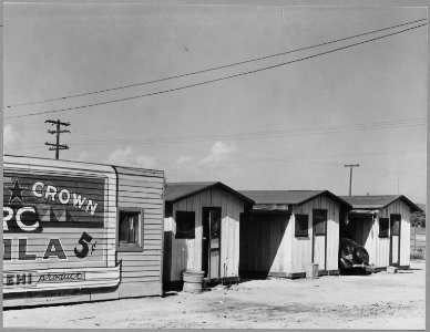 Sunset District, East Bakersfield, Kern County, California. Row of cribs adjoining recreation center . . . - NARA - 521666 photo