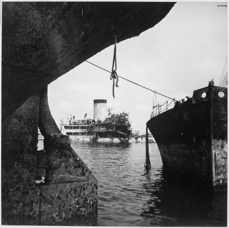 Sunken Japanese ships in Manila Bay are being refloated by Navy salvage crews, towed to deeper water, and re-sunk.... - NARA - 520955
