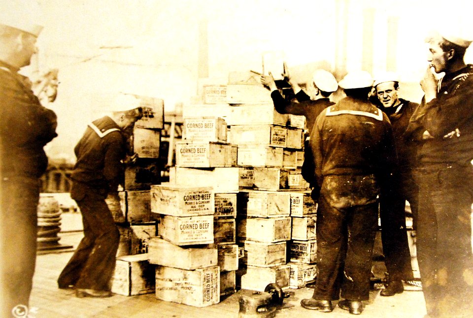 Supplies of corn beef being stacked by sailors (25987284654)