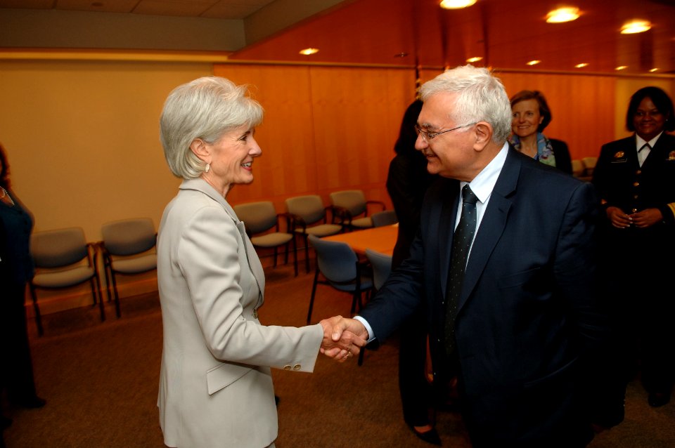 Surgeon General Regina Benjamin looks on as Secretary Sebelius shakes the hand of EU commissioner Olli Rehn