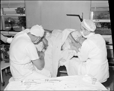 Surgeon putting pin in broken hip of an old lady. Clinch Valley Clinic Hospital, Richlands, Tazewell County, Virginia. - NARA - 541100 photo