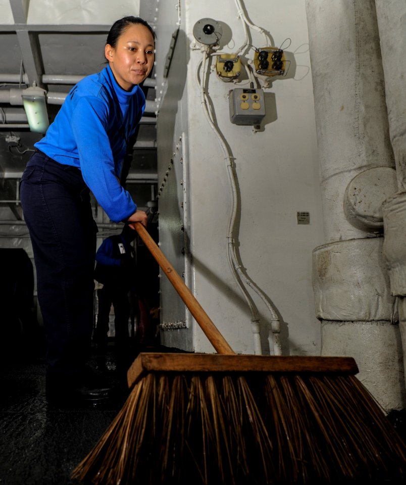 Sweeping water out of the hangar bay 130118-N-PW661-002