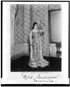 Sybil Sanderson, full-length portrait, standing, facing right, holding up mirror and looking into it LCCN94509767