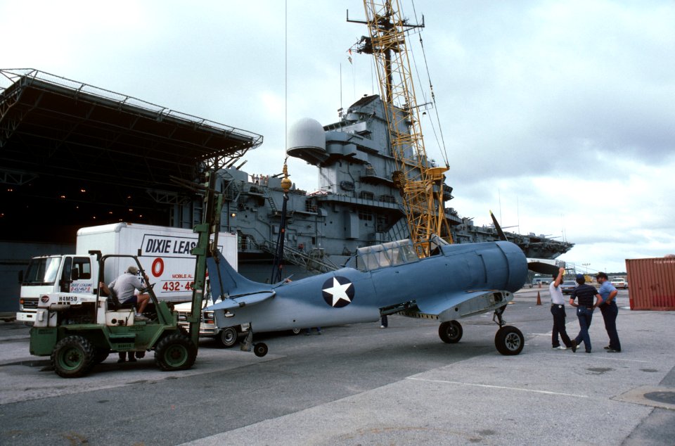 T-6 is lifted on USS Lexington (AVT-16) for filming of War and Remembrance in 1987