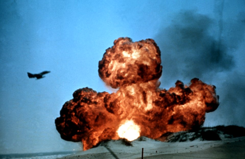TA-4 Skyhawk flies ovr bomb explosion in 1984