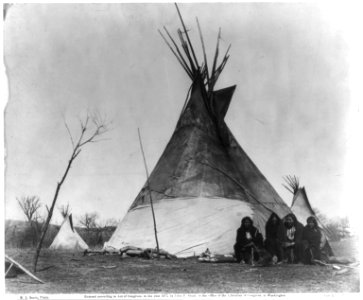 Ta-Her-Ye-Qua-Hip or Horse-backs Camp; 4 comanches in front of wigwam, Fort Sill, Indian Territory LCCN2016649448