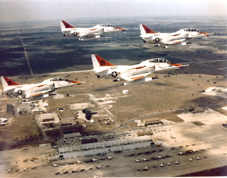 TA-4J Skyhawks VT-21 in flight over airfield c1980s
