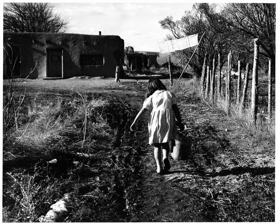 Taos County, New Mexico. Children help to carry water from the ditch or well for domestic use. - NARA - 521821