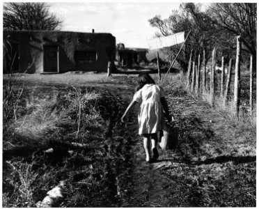 Taos County, New Mexico. Children help to carry water from the ditch or well for domestic use. - NARA - 521821