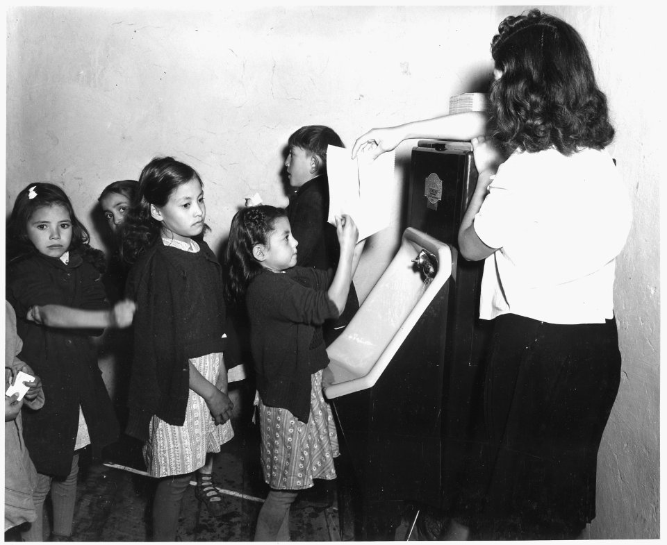 Taos County, New Mexico. Children wash their hands before lunch at the Penasco School. The washing . . . - NARA - 521839