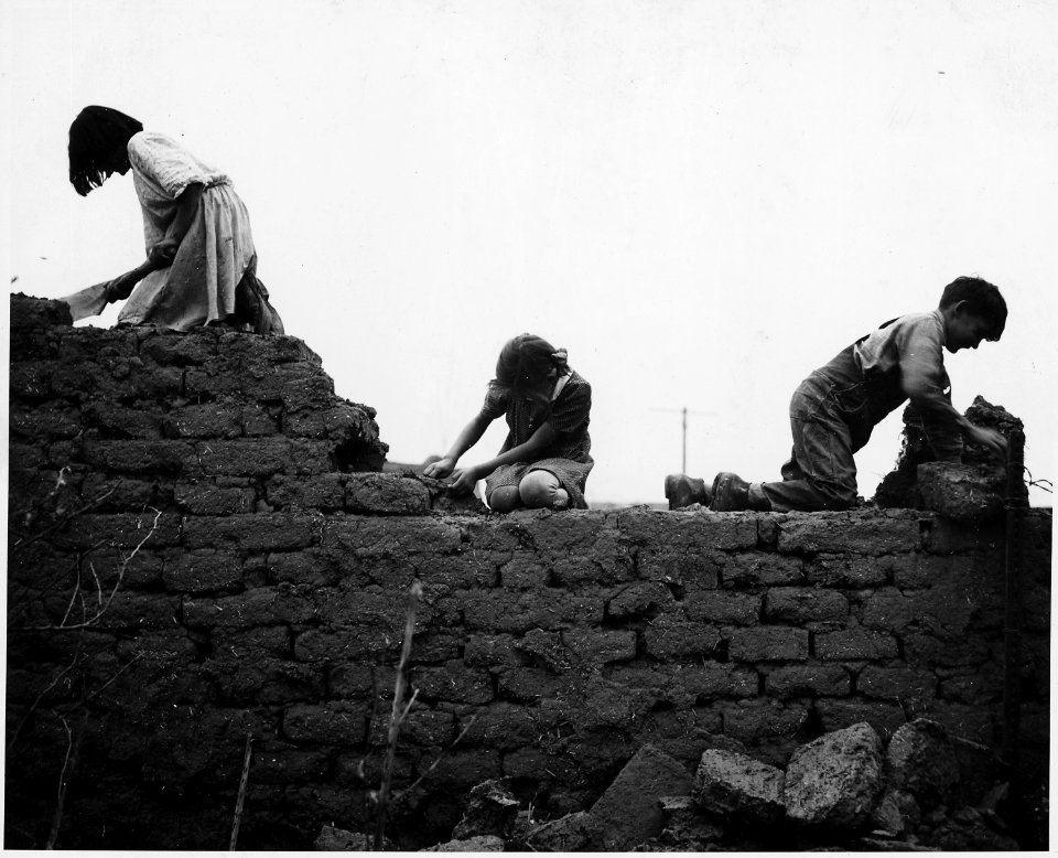 Taos County, New Mexico. Children help to tear down abandoned building. - NARA - 521987
