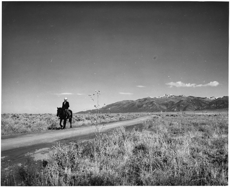 Taos County, New Mexico. The road to Arroyo Seco, in the distance, the Sange de Cristo Mountains, f . . . - NARA - 521822