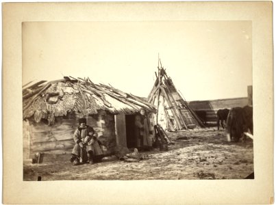 Tatar couple with a small boy in front of their home LCCN99615498