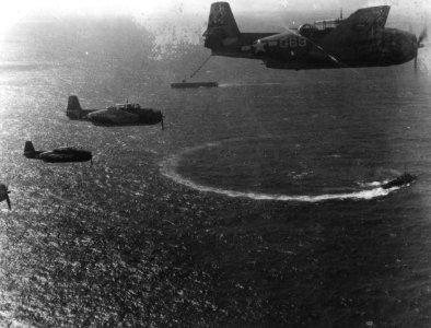 TBF Avengers in flight over USS Shipley Bay (CVE-85) c1945