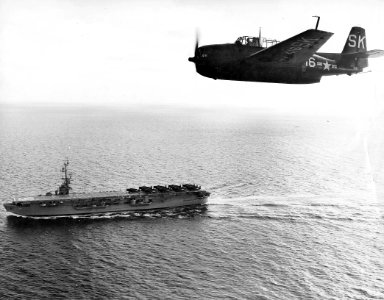 TBM-3E over USS Badoeng Strait CVE-116