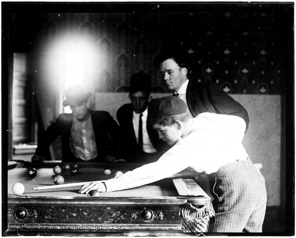 Teaching the young rider how to start. A common scene in Pool Room Branch. St. Louis, Mo. - NARA - 523302