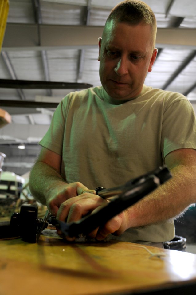 Tech. Sgt. Daniel Dinges, 380th Expeditionary Logistics Readiness Squadron, vehicle maintenance, removes a light switch shaft