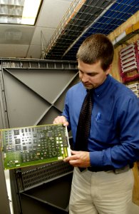 Technician checks circuit card photo