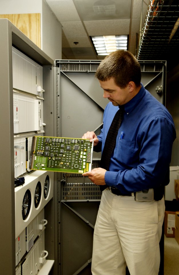 Technician replacing circuit card