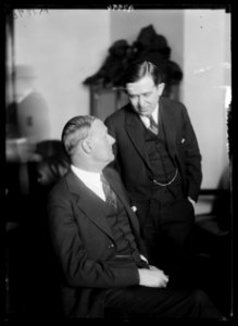 Tex Rickard, seated, famous fight promoter, with his attorney Hyman Bushel, at the Daugherty hearing LCCN2016887152