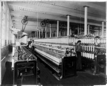 Textile factory with two women at machines LCCN2004674560
