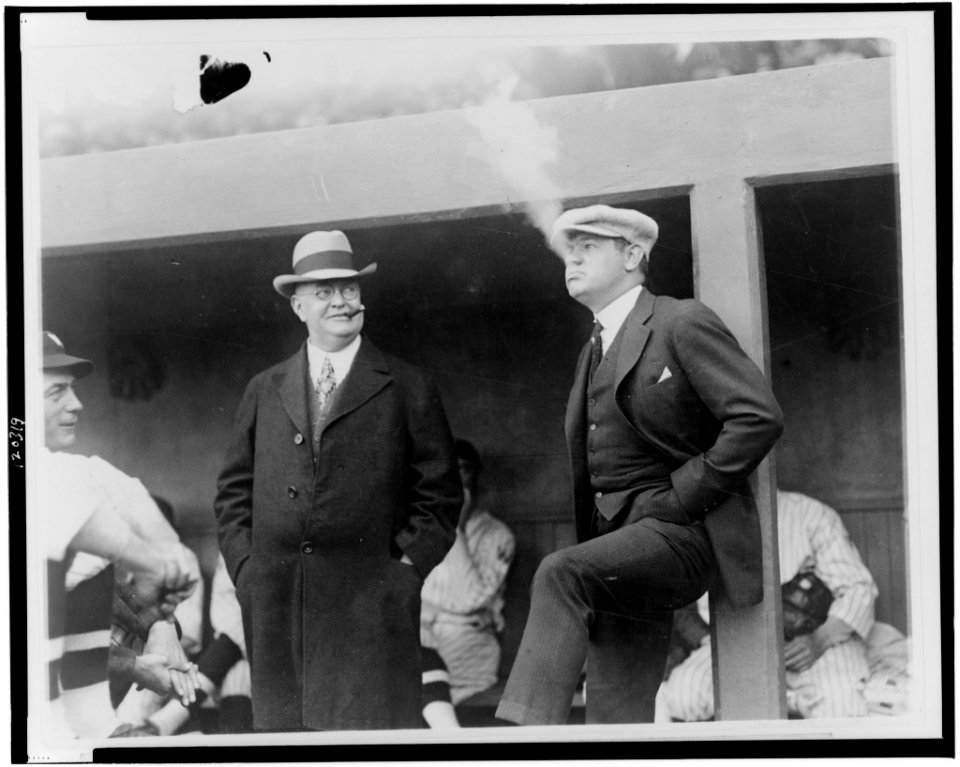 The Babe in a reflectice (sic) mode, snaped (sic) in the Wash (Washington, D.C.) dugout before the game-President Ban Johnson seems to enjoy the situation LCCN98502171