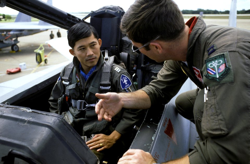 The 67th Tactical Fighter Squadron life support officer explains the ejection seat to a Thai pilot prior to his familiarization flight in an F-15 Eagle aircraft