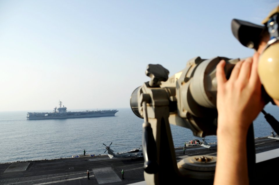 The aircraft carrier USS Carl Vinson (CVN 70), background, relieves the aircraft carrier USS George H.W. Bush (CVN 77) in the Persian Gulf Oct. 18, 2014, during Inherent Resolve 141018-N-MU440-006