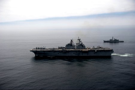 The amphibious assault ship USS America (LHA 6), front, and a Peruvian Navy ship sail in formation during a passing exercise in the Pacific Ocean Sept 140903-N-MZ309-722